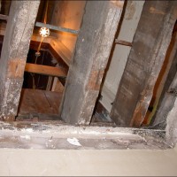 STRUCTURAL ANALYSIS: Inspecting condition of floor joist.