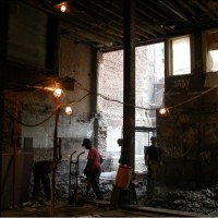 CREATING THE AUDITORIUM:  View of the remaining rear wall and yard.