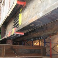 CREATING THE AUDITORIUM: 
New 35-foot long built-up double steel girder being set in place to carry the five stories of masonry rear wall above the auditorium space.
