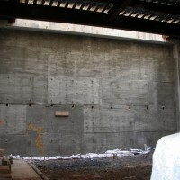 CREATING THE AUDITORIUM:  New concrete rear wall in rough form.