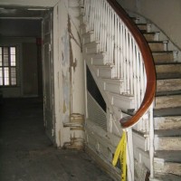 EXISTING CONDITIONS 2001: Original east stair and paneling showing extensive water damage.